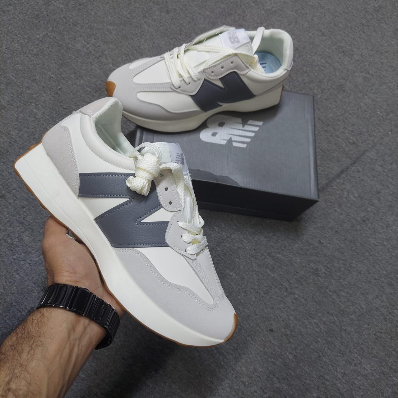 White and gray sneakers with blue accents