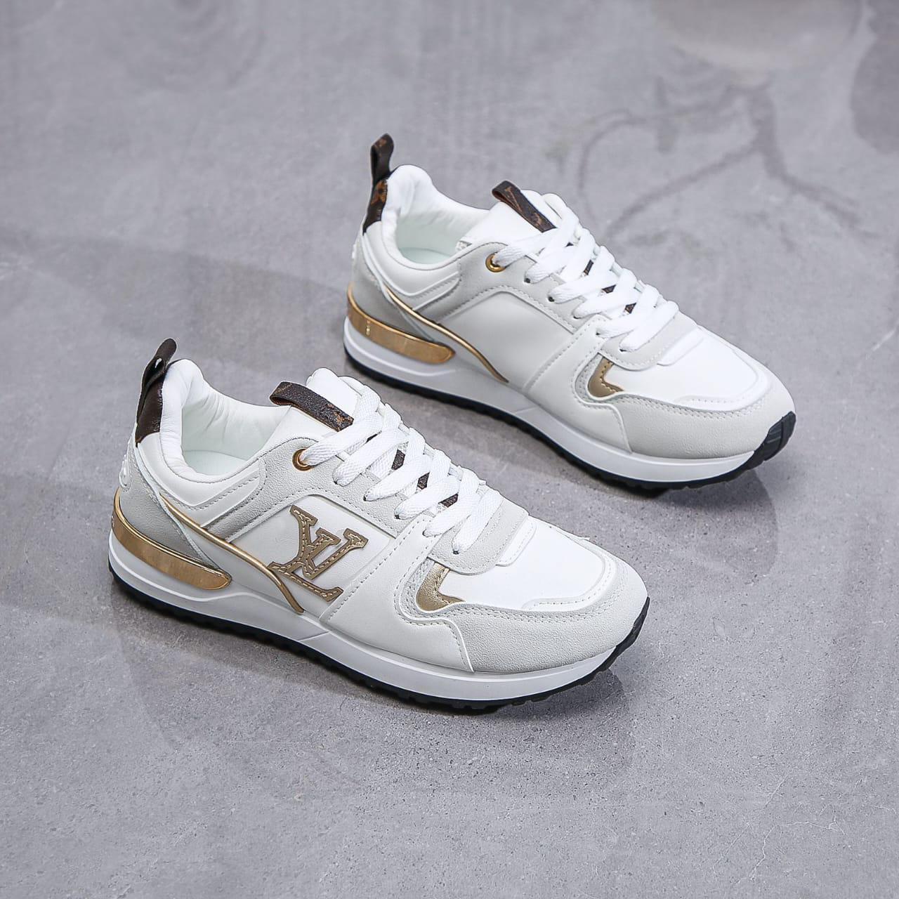 White sneakers with gold accents