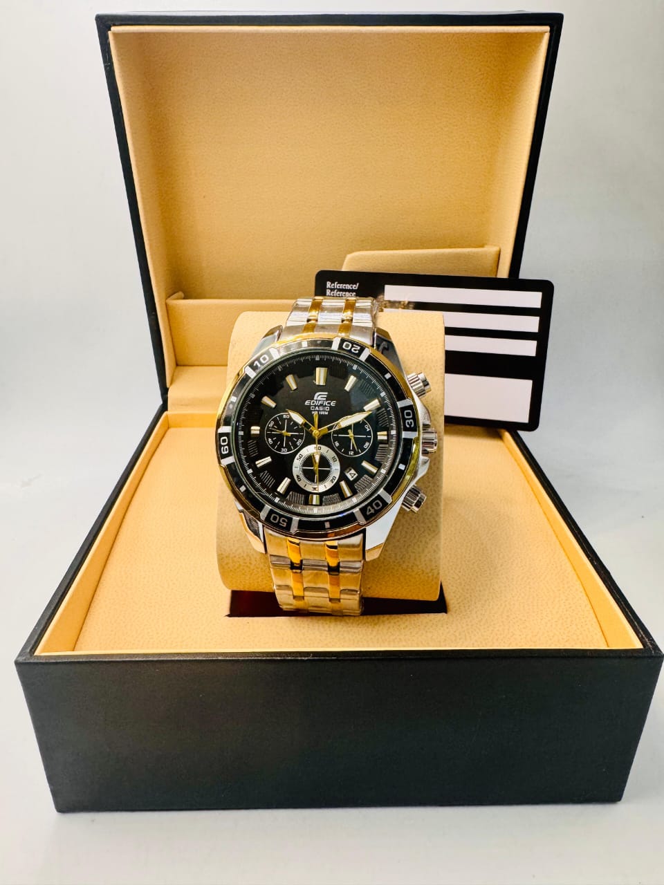 Luxury watch with black face and gold accents