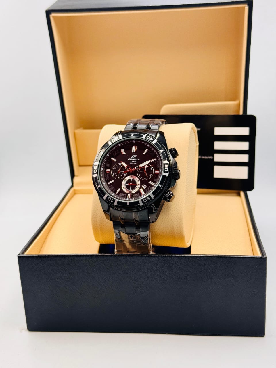 Black wristwatch in a black and beige display